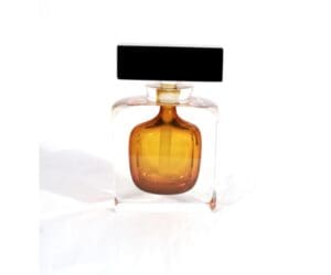 A bottle of perfume sitting on top of a table.