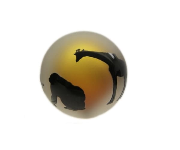 A ball with silhouettes of giraffes and monkeys.