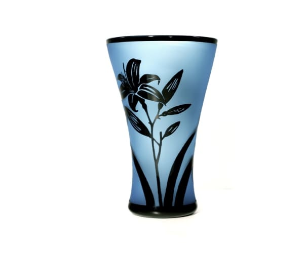 A blue vase with black flowers on it.