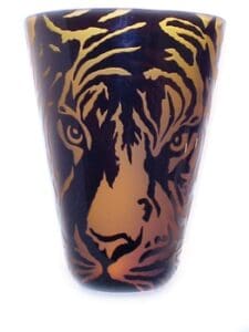 A close up of the face on a cup