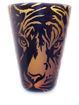 A close up of the face on a cup