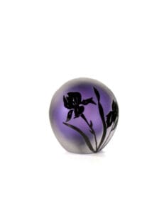 A purple glass vase with black flowers on it.
