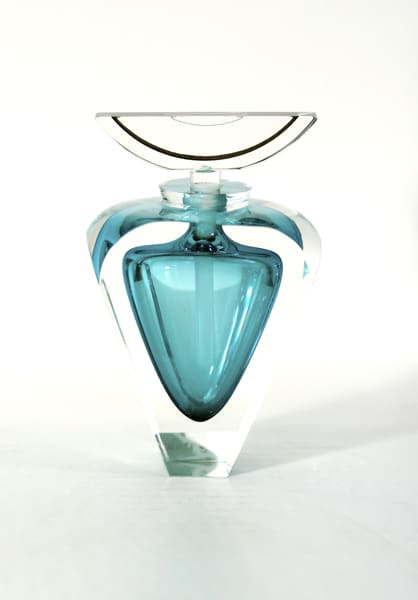 A blue glass vase with a white lid.