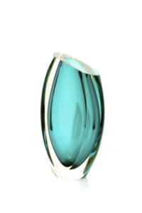 A glass vase with a blue tint on top of it.