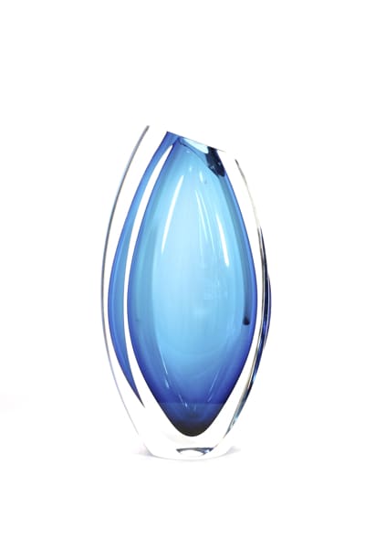 A blue glass vase with a clear base.