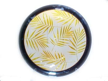 A round plate with yellow leaves on it.