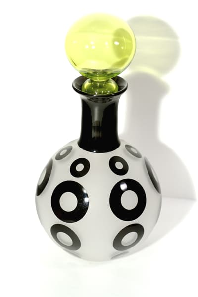 A black and white vase with circles on it