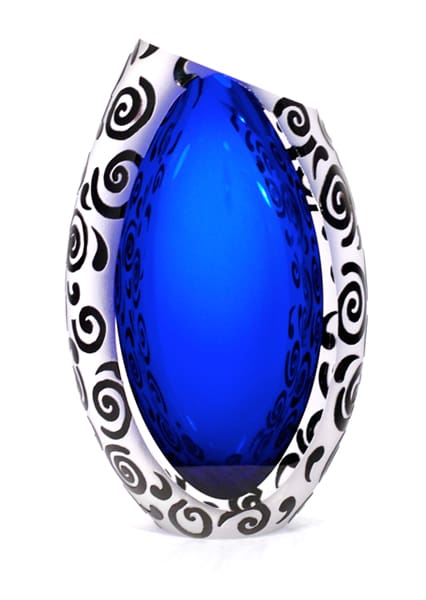 A blue glass object with black swirls around it.