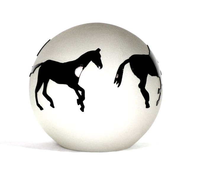 A white ball with two black horses on it.
