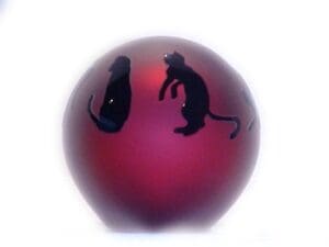 A red ball with two cats on it