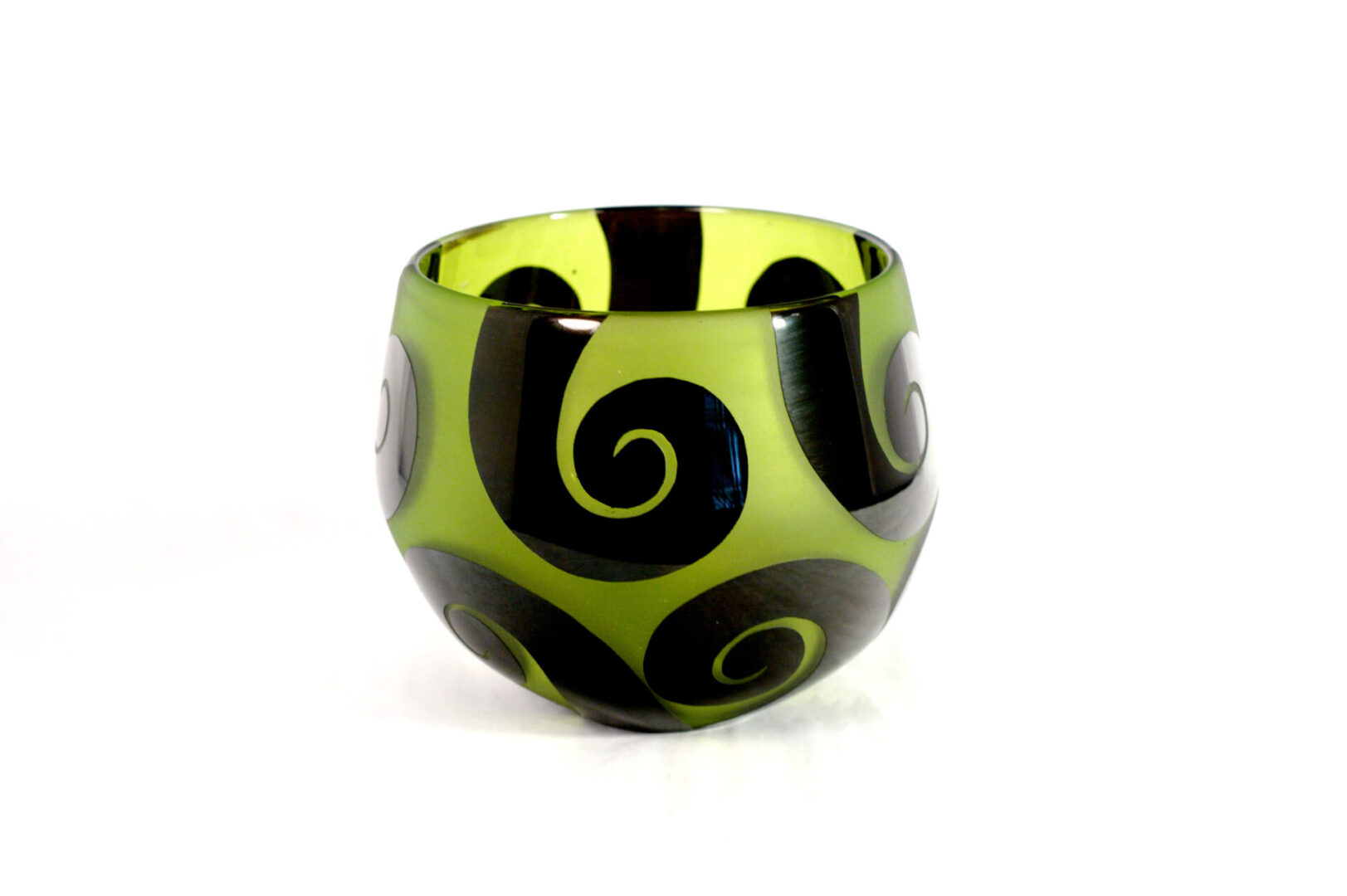 A green and black glass bowl with swirls