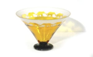 A glass bowl with yellow elephants on it.