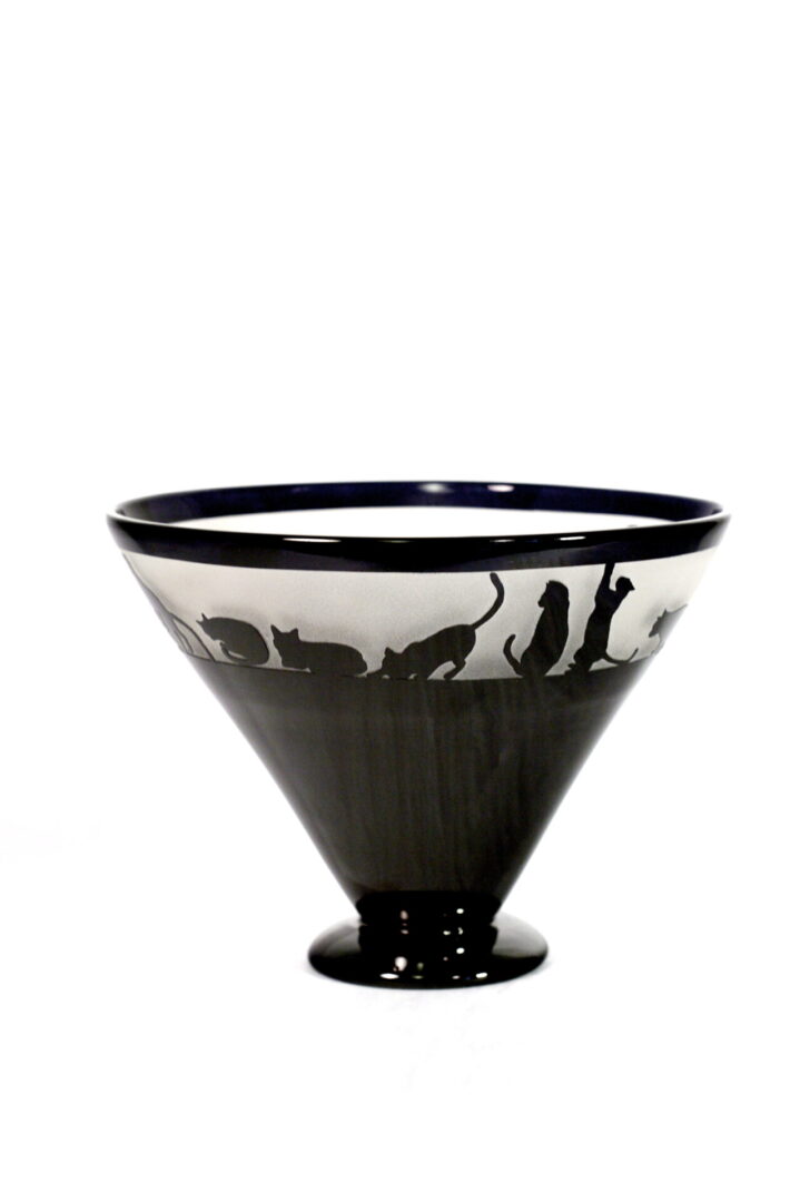A black and white bowl with cats on it