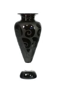 A black vase with swirls on it
