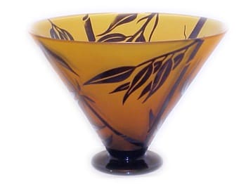 A glass bowl with brown leaves on it.