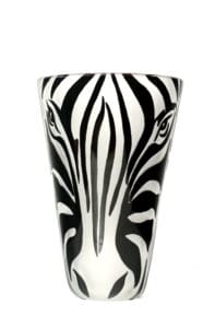 A zebra face painted on the side of a glass.