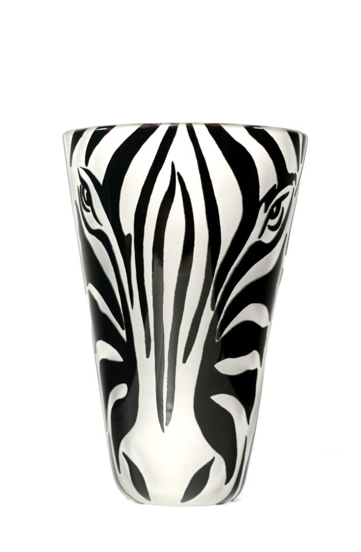 A zebra face painted on the side of a glass.