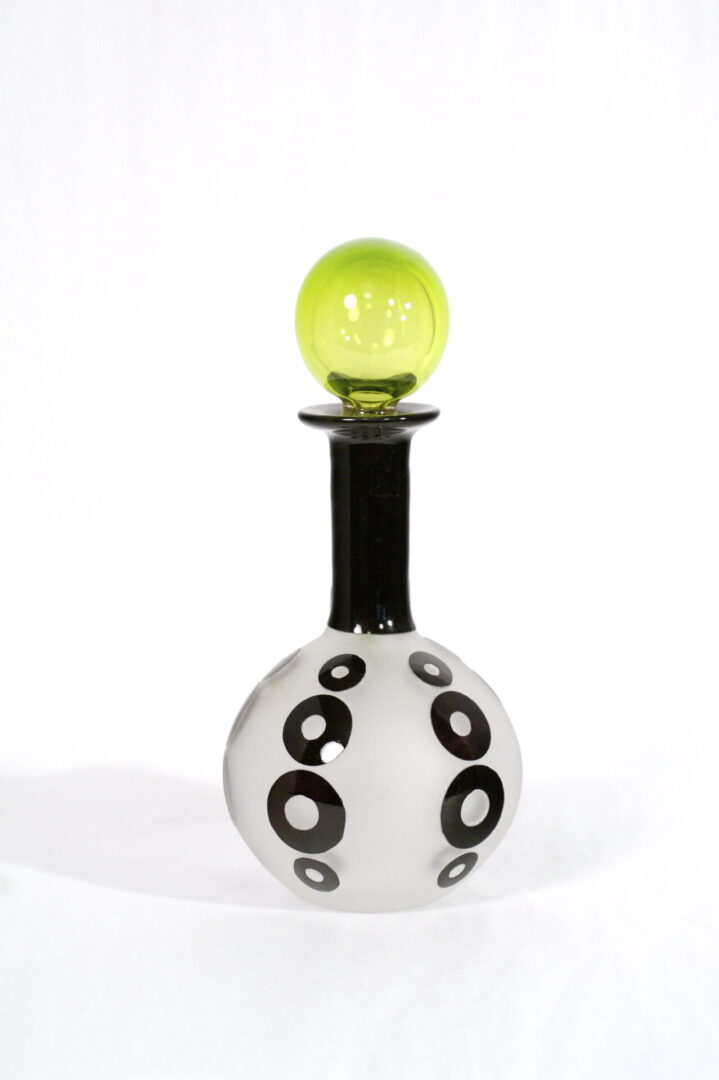 A black and white bottle with a yellow top