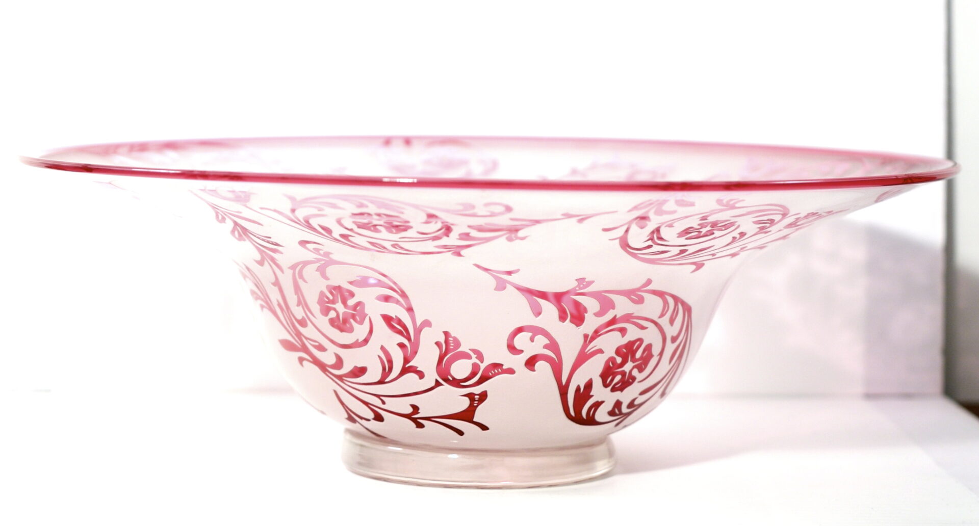 A bowl with red and white design on it.