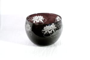 A bowl with white flowers on it