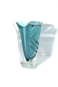 A glass vase with blue and white design on it.