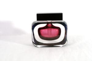 A bottle of perfume sitting on top of a table.