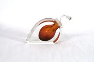 A glass heart with a brown and orange design.