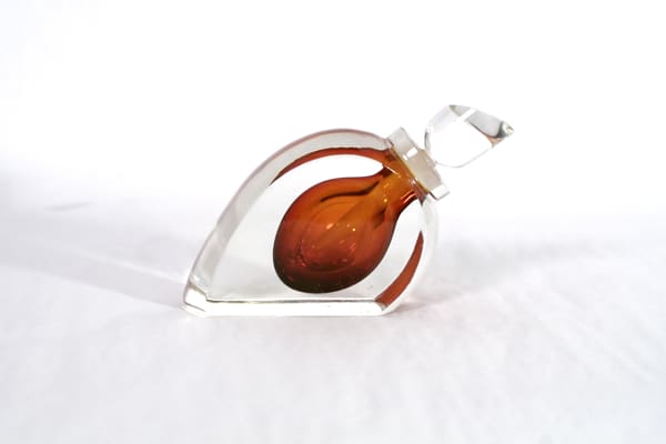 A glass heart with a brown and orange design.