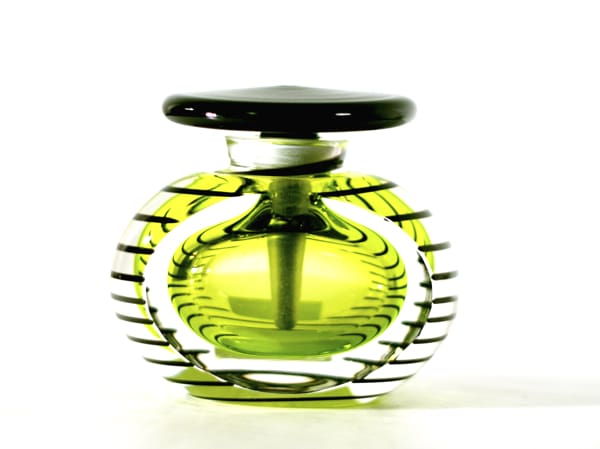 A green glass bottle with a black lid.