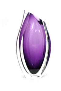 A purple glass vase sitting on top of a table.