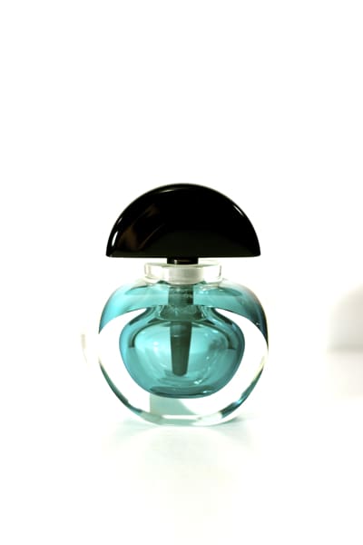 A bottle of perfume sitting on top of a table.
