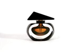 A black and brown bottle of perfume on top of a table.