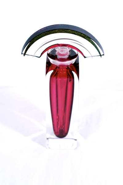A red glass vase with a black and white striped design.