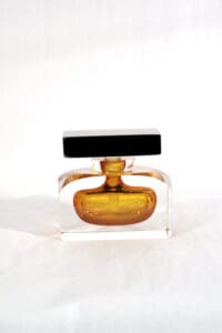 A bottle of perfume sitting on top of a table.