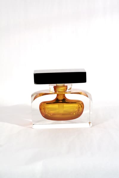 A bottle of perfume sitting on top of a table.