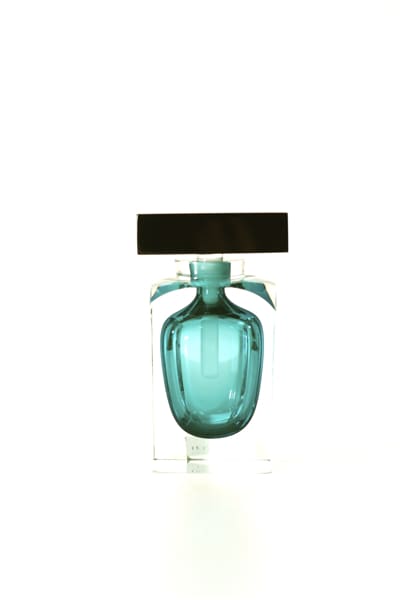A bottle of perfume on display in front of a white background.
