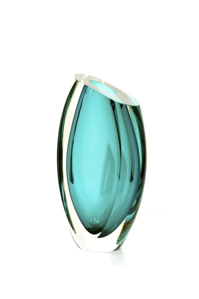 A glass vase with a blue tint on top of it.