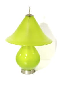A green lamp is sitting on the floor.