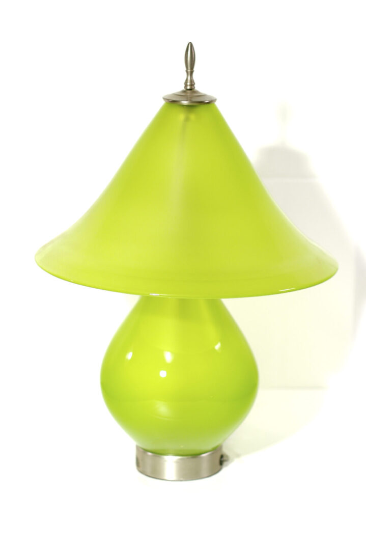 A green lamp is sitting on the floor.