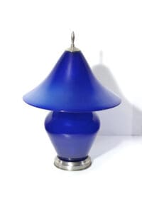 A blue lamp sitting on top of a table.