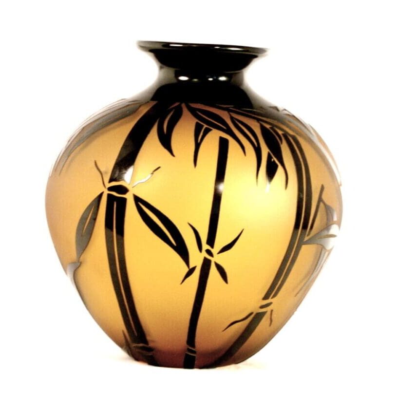A vase with black and gold design on it.
