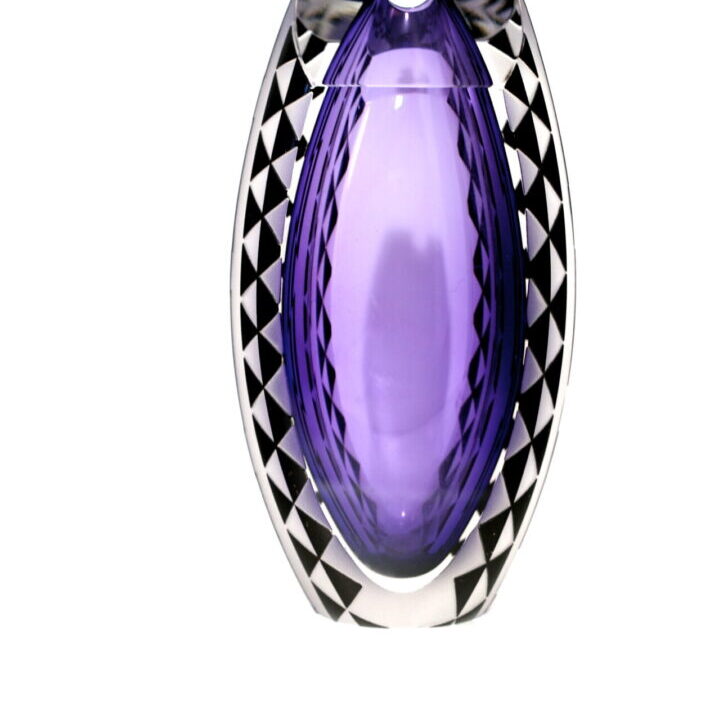 A purple glass vase with black and white checkered design.